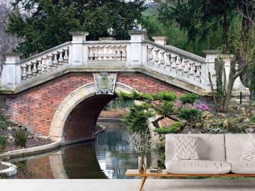 Garden Bridge Wallpaper, as seen on the wall of this living room, is a photo mural of an old bridge in Parc Monceau, Paris inspired by the Rialto Bridge from About Murals.