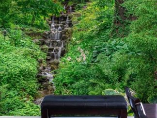 Green Waterfall Wallpaper, as seen on the wall of this music room, is a high resolution photo mural of a layered waterfall cascading down rocks surrounded by trees, plants and foliage from About Murals.