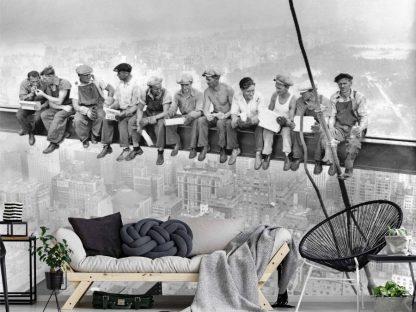 Lunch Atop a Skyscraper Wallpaper, as seen on the wall of this living room, is a black and white photo mural of eleven construction workers sitting on a girder 850 feet above New York City from About Murals.