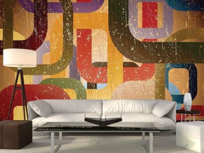 Mid Century Geometric Wallpaper, as seen on the wall of this living room, is a wall mural with a yellow, gold, orange and green pattern from About Murals.
