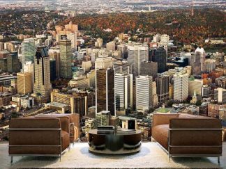 Montreal City Wallpaper, as seen on the wall of this living room, is a photo mural of a Quebec skyline in autumn from About Murals.