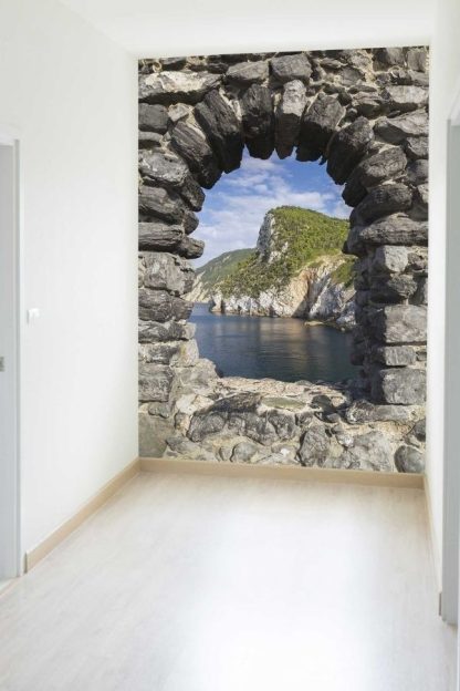 Stone Arch Wallpaper, as seen on the wall of this hallway, is a photo mural of the gulf of the poets, Porto Venere, Italy from About Murals.