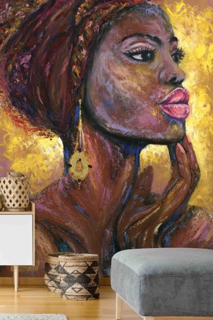 African Woman Wallpaper, as seen on the wall of this living room, is a mural of a beautiful black girl's face against a vibrant yellow background painted in oil paint from About Murals.