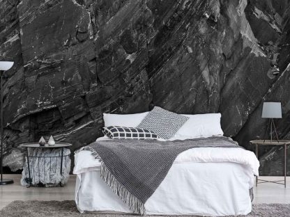 Black Rock Wallpaper, as seen on the wall of this bedroom, is a photo mural of ridges and cracks in a cliff wall from About Murals.