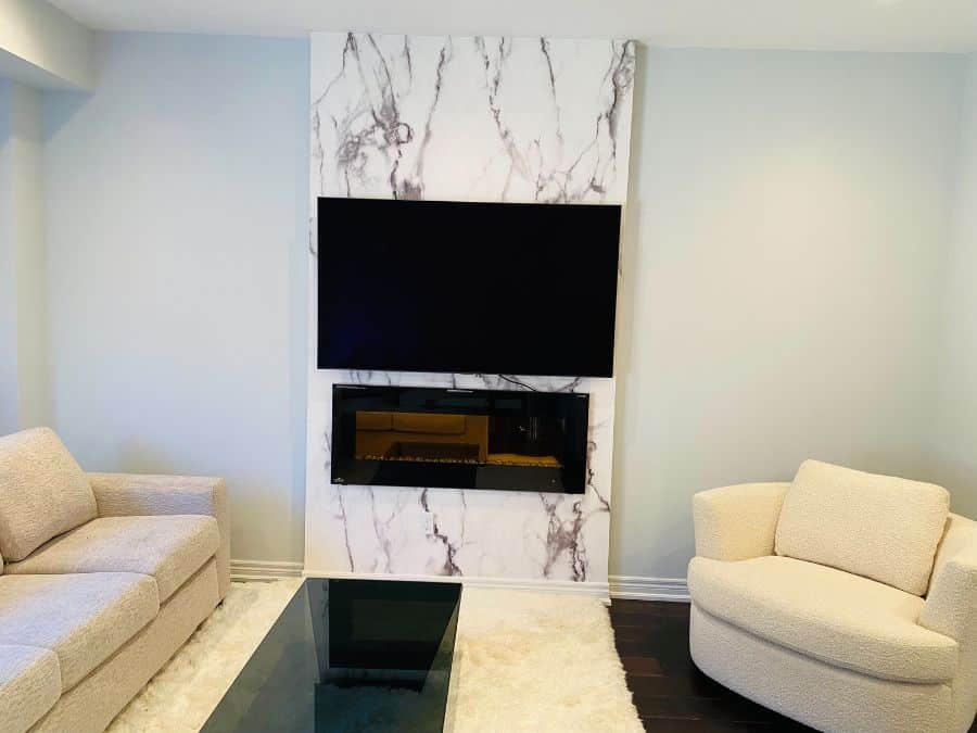 Grey and White Marble Wallpaper, as seen on the wall of this fireplace surround, is a high resolution photo mural of a white marble effect with grey veining from About Murals.