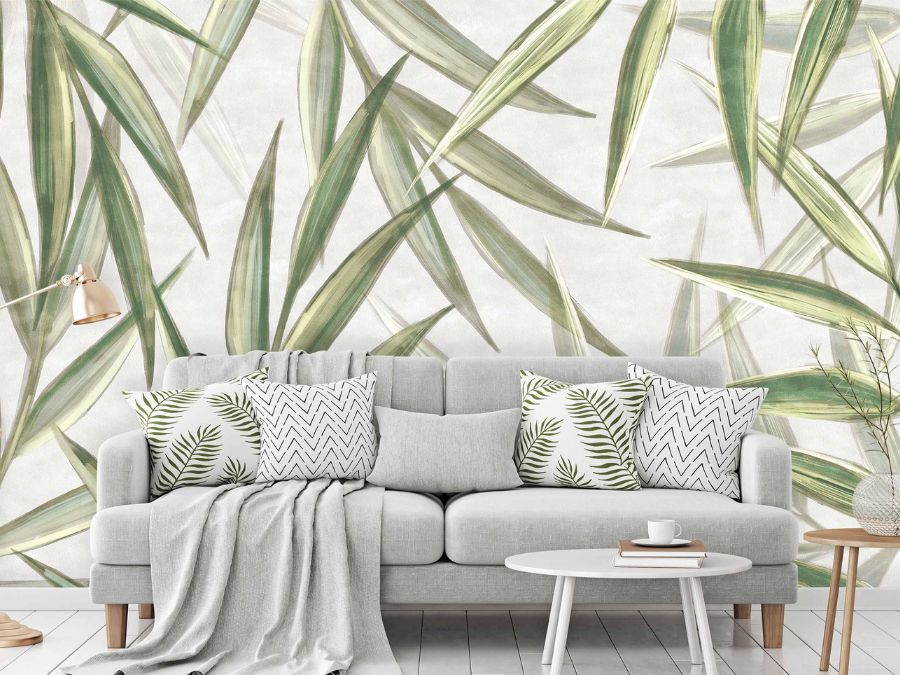 Light Green Botanical Foliage Wallpaper, as seen on the wall of this living room, is a wall mural with large green leaves on a light background from About Murals.