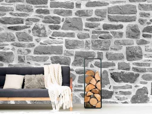 Rock Wall Wallpaper, as seen on the wall of this living room, is a high resolution photo mural of a grey stone wall with white mortar from About Murals.