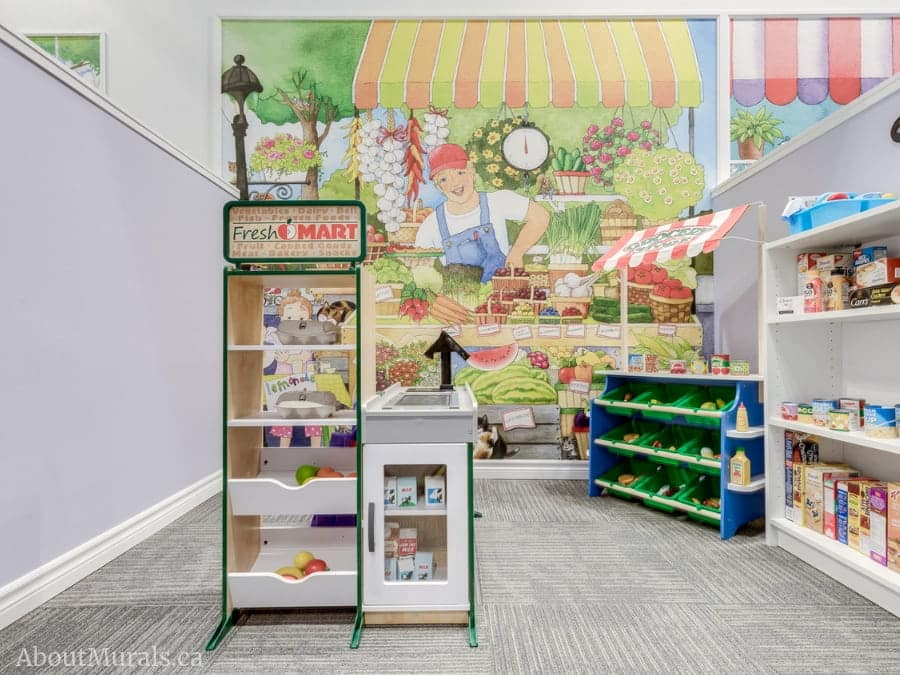 Indoor Playground Wallpaper, as seen on the wall of Playville, is a kids mural of a farmer at a market stall from About Murals.