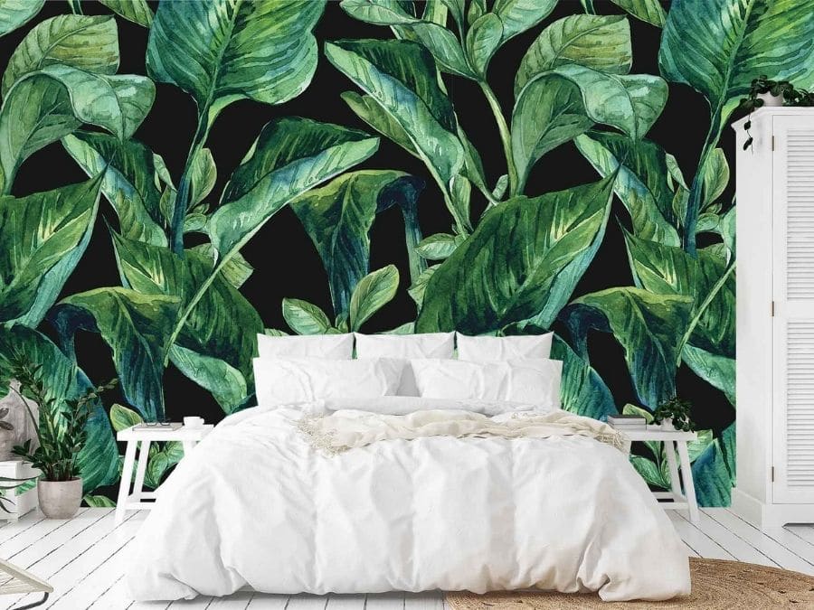 Shop Hamilton wallpaper, like this tropical leaf wall mural in a bedroom, from About Murals.