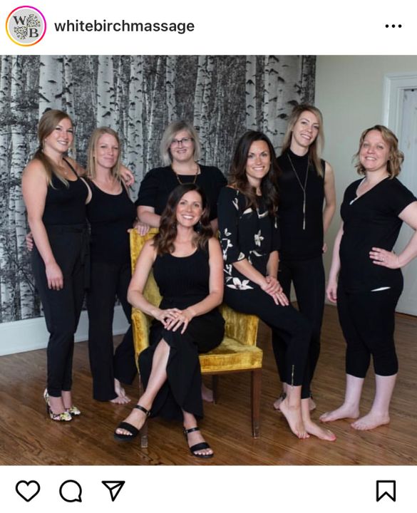 Photo of eco-friendly wallpaper features seven women in front of a birch wallpaper from White Birch Massage and Wellness Center, purchased from About Murals.