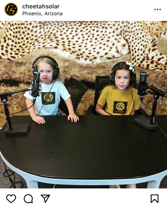 Photo of eco wallpaper features two kids in front of a cheetah mural from Cheetah Solar, purchased from About Murals.