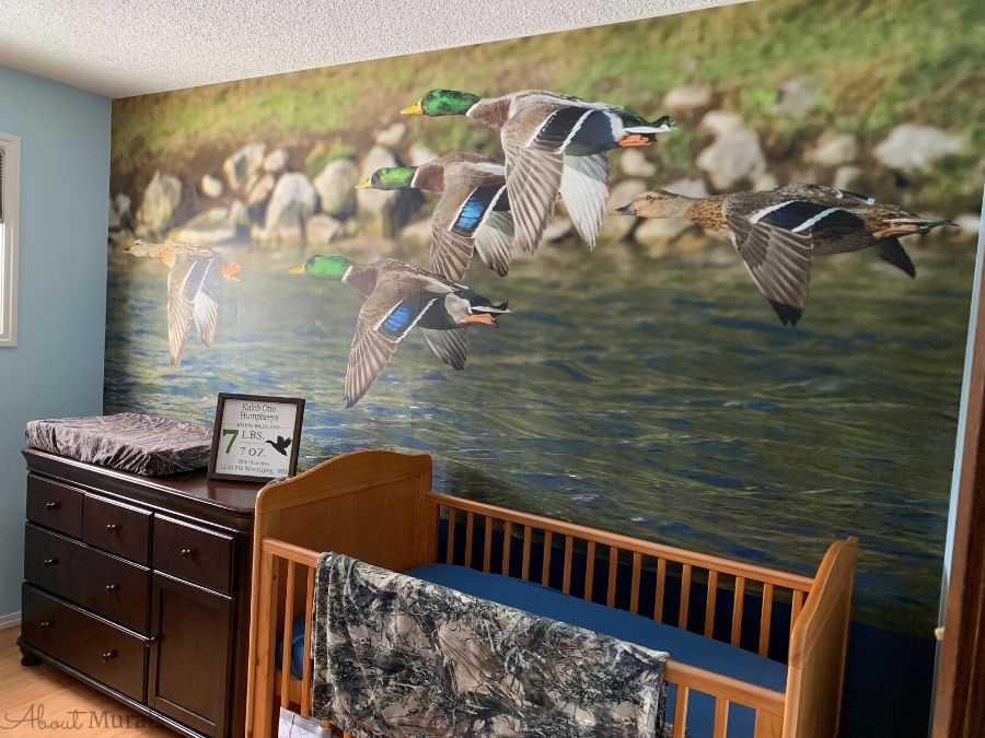 Custom photo wallpaper murals, like this hunting themed design in a nursery, are printed by About Murals in Canada.