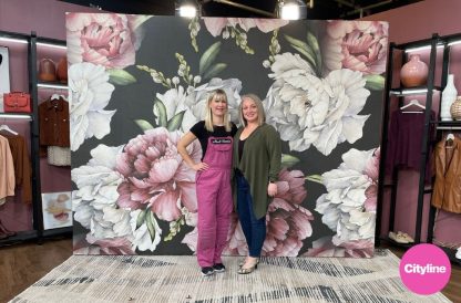 Black and Pink Floral Wallpaper, as seen on Cityline with Leigh-Ann Allaire Perrault and Adrienne Scanlan, is a mural with large pink and white peony flowers on a dark background from About Murals.