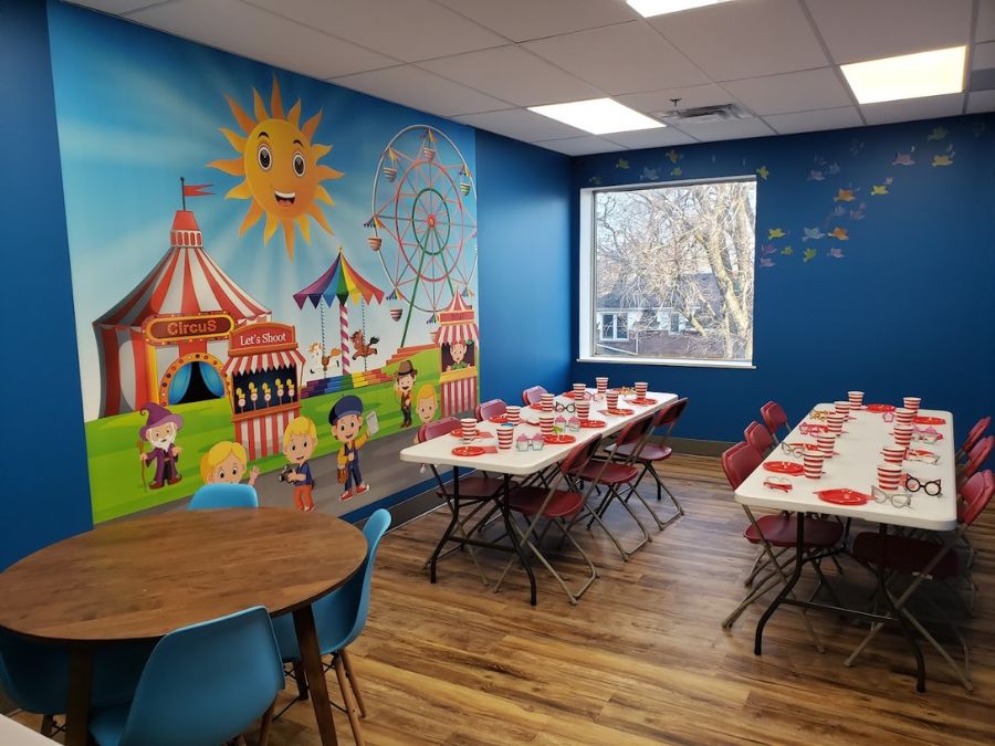 Children's party venue ideas, like this carnival themed room with circus wallpaper from About Murals, is a fun way for kids to celebrate a birthday.
