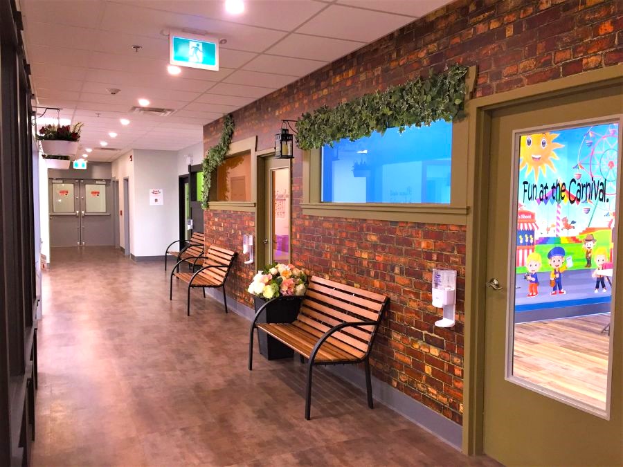An indoor play town, created with red brick wallpaper in a hallway, as an indoor playground business idea from About Murals