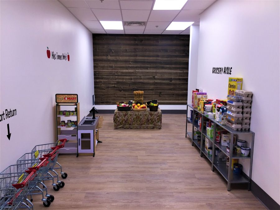 Pretend grocery store with barn wood wallpaper from About Murals.
