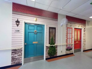 Dementia door wraps, one blue and one red, that helps residents find their bedroom in a long term care facility from About Murals.