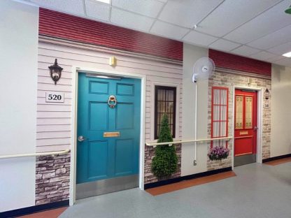 Dementia door wraps, one blue and one red, that helps residents find their bedroom in a long term care facility from About Murals.